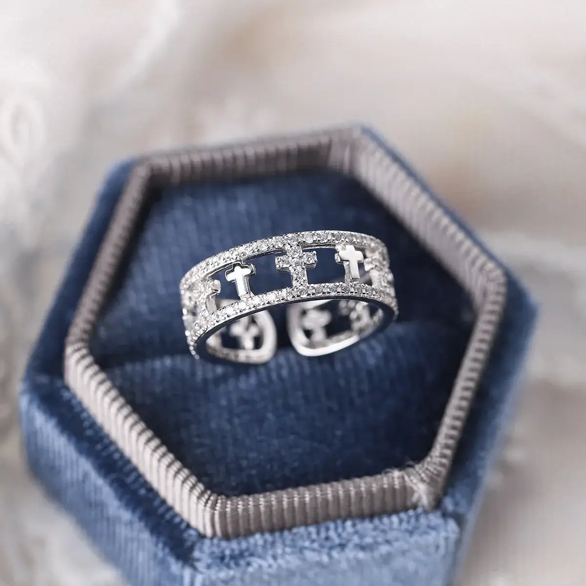 Double-ring with Christian cross and diamonds on blue box