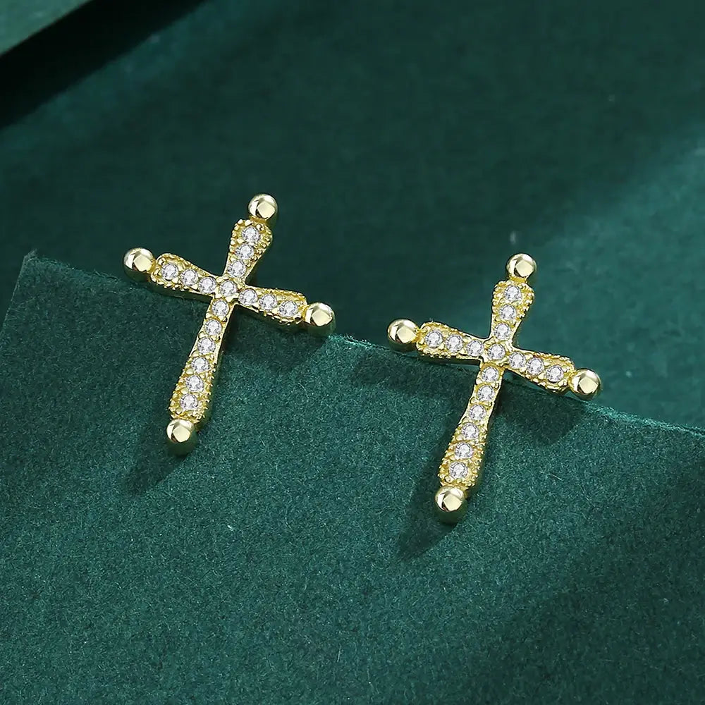 Earrings with a Christian cross in gold on green background