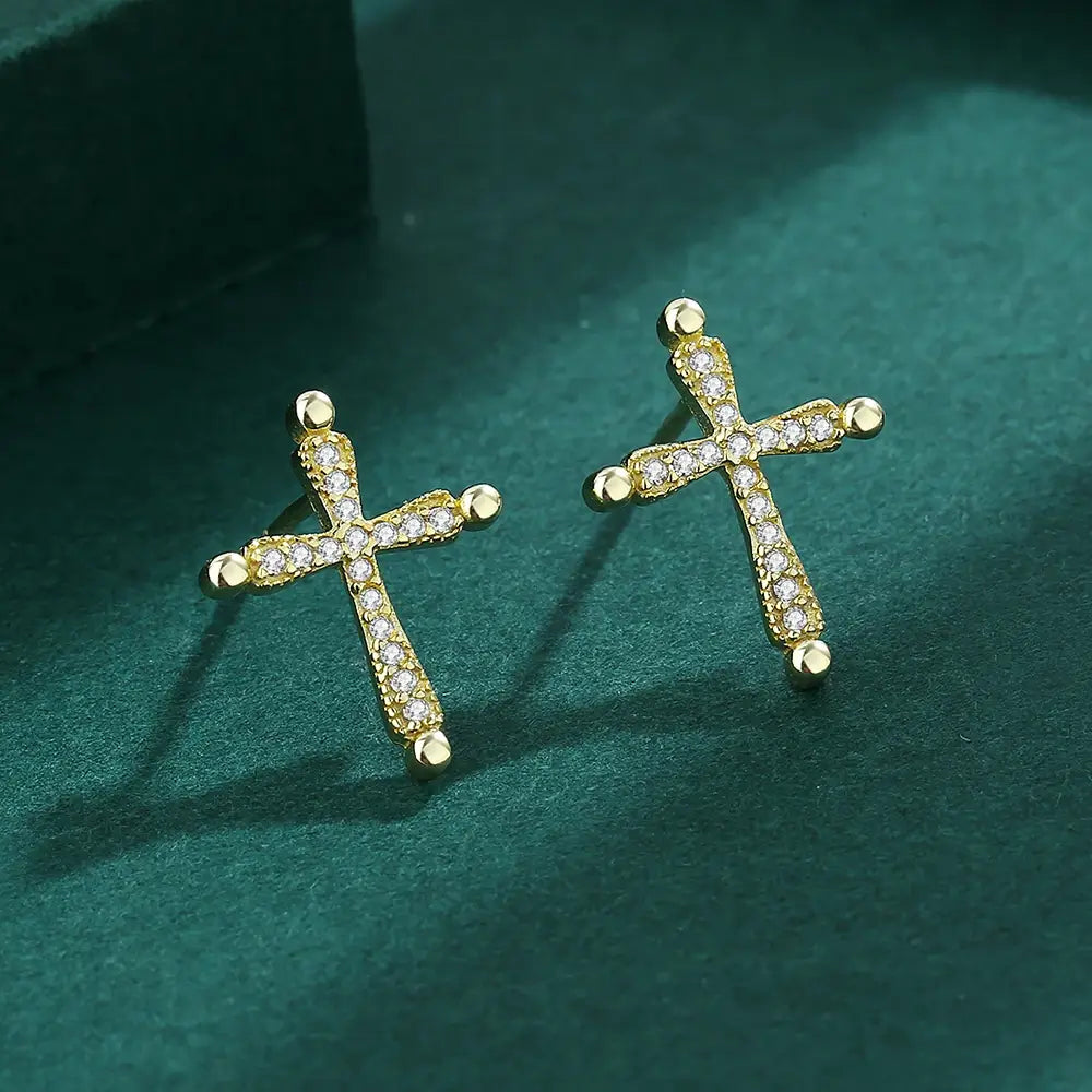 Earrings with a Christian cross in gold on green background