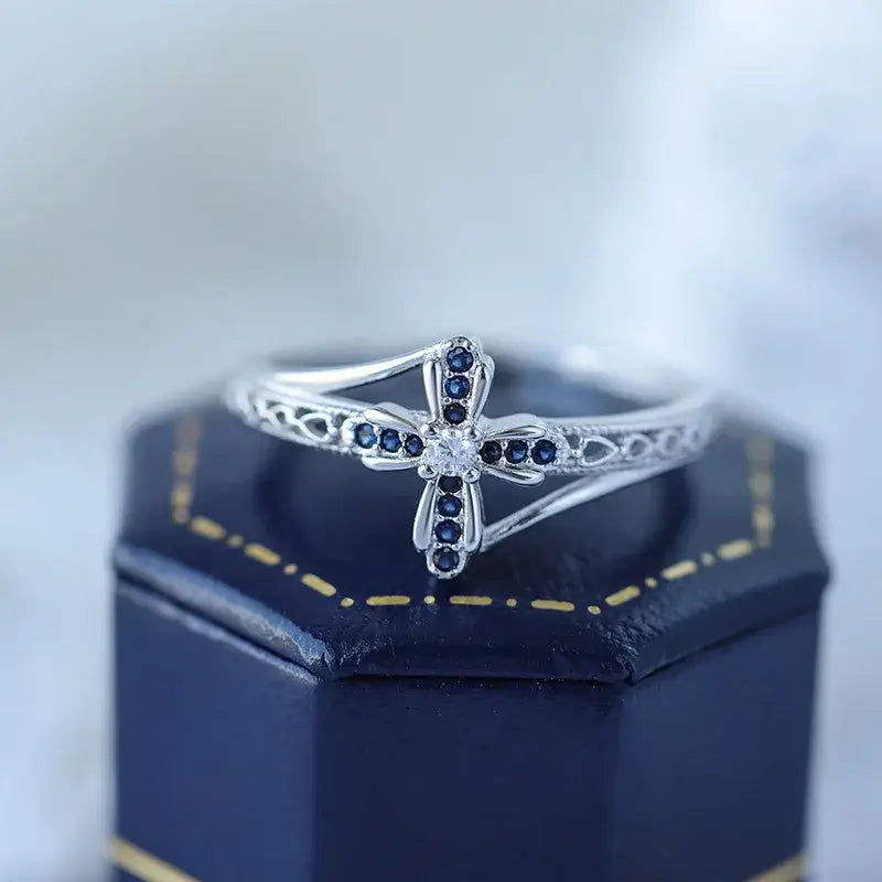 Sapphire christian cross ring on blue box