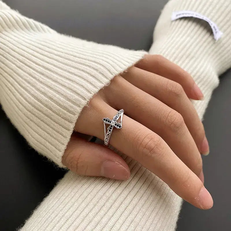 Sapphire christian cross ring on finger of woman